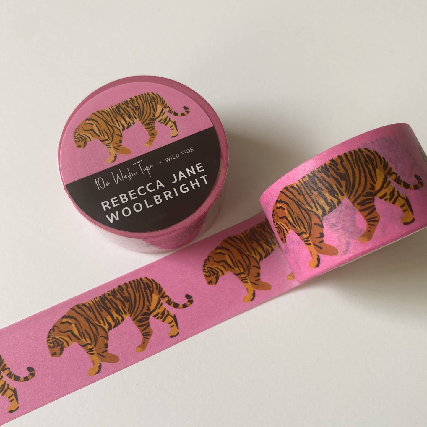 Roll of Wild Side Washi Tape showing bold tiger design on pink background