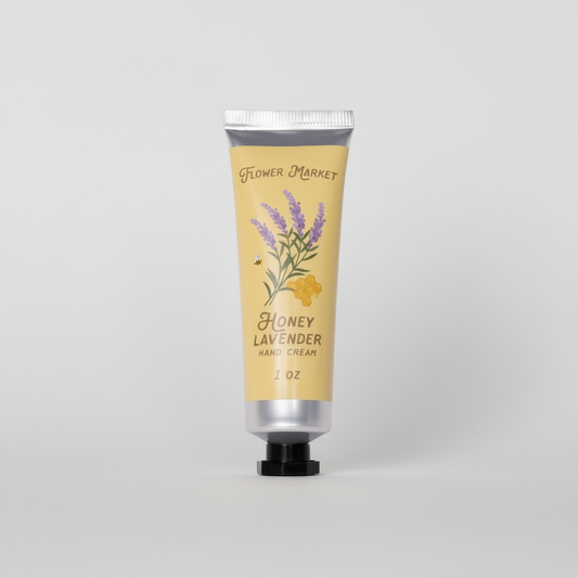 Hand cream tube labeled 'Flower Market Honey Lavender' on a white background