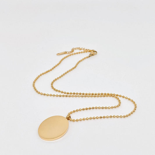 Image of the back side of the gold necklace on a light gray background