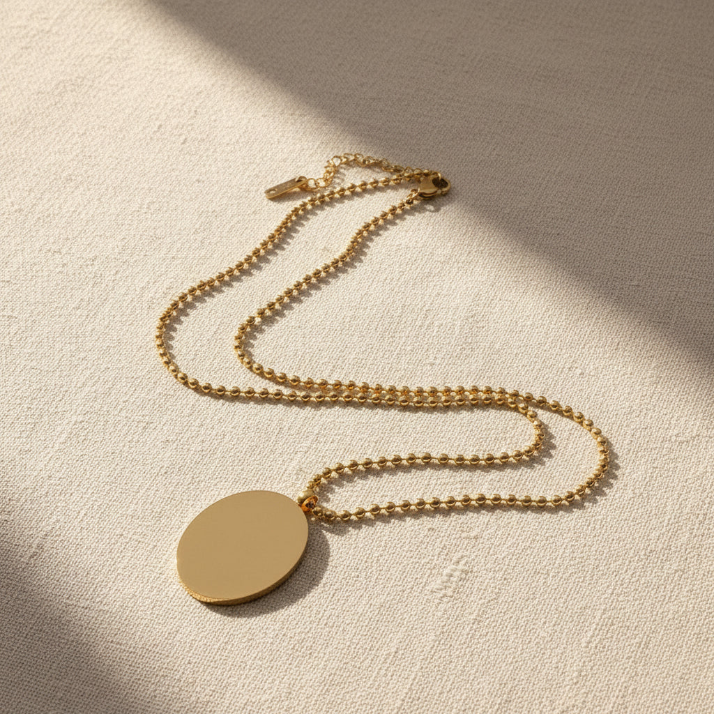 Image of the back side of the gold necklace on a light gray background