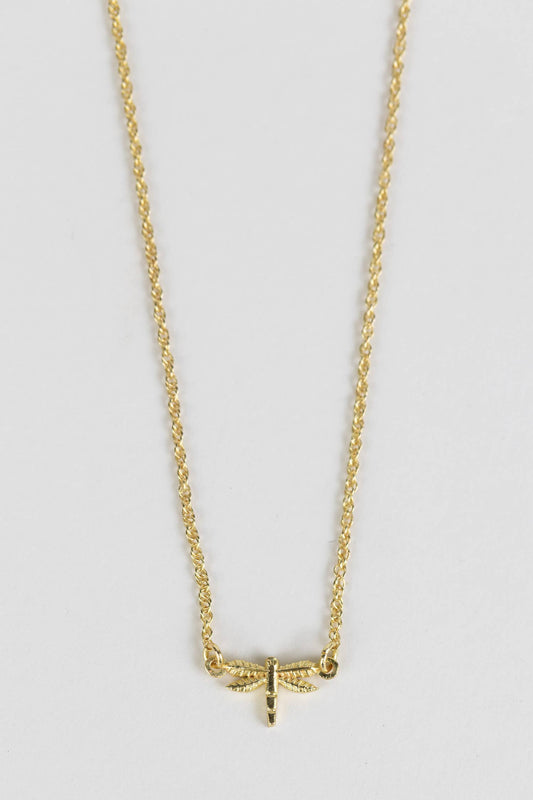 Minimalist dragonfly necklace styled as a meaningful everyday accessory