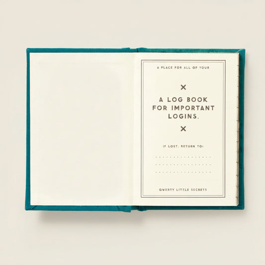 Open mini teal notebook with a log book for important logins on a white background
