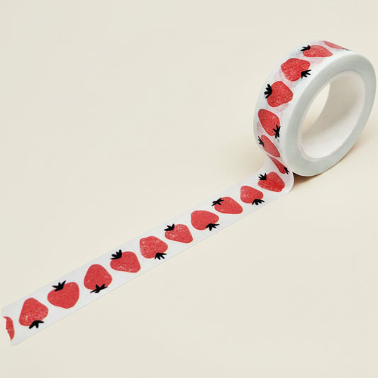 Roll of washi tape with strawberry pattern on a white background
