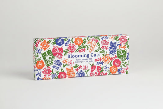 Box of 'Blooming Cats' rubber stamp set with colorful floral and cat designs on a white background.