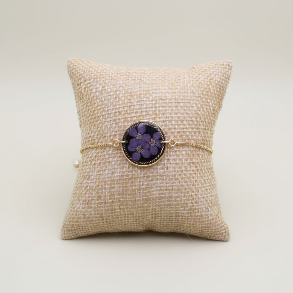 Bracelet with floral design on a textured beige surface