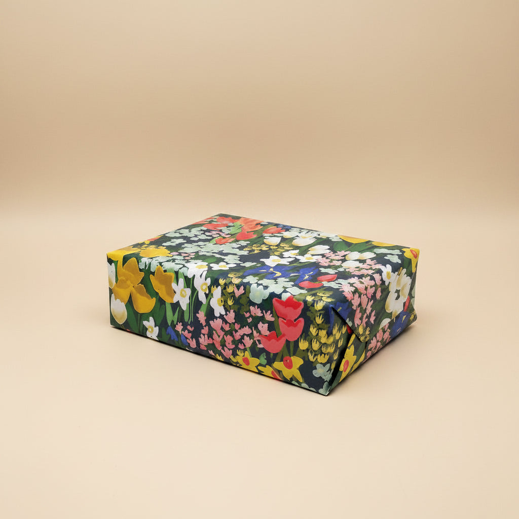 Meadow wrapping paper with floral-patterns wrapped around a box on a white background