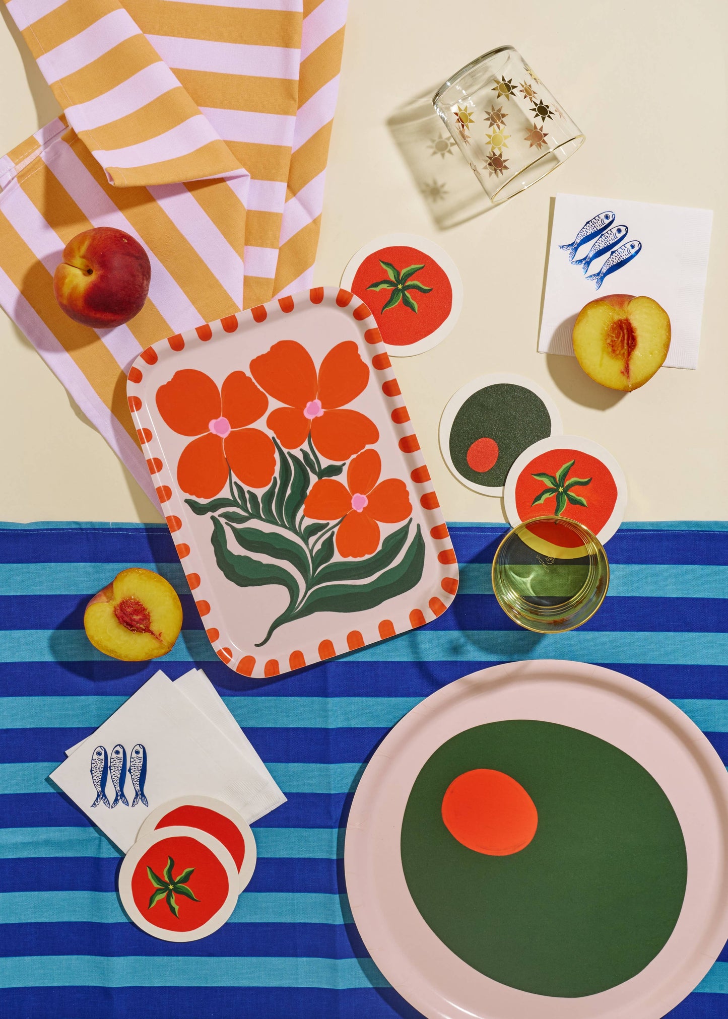 Tomato coasters aired with other table decor creating a fun summer theme
