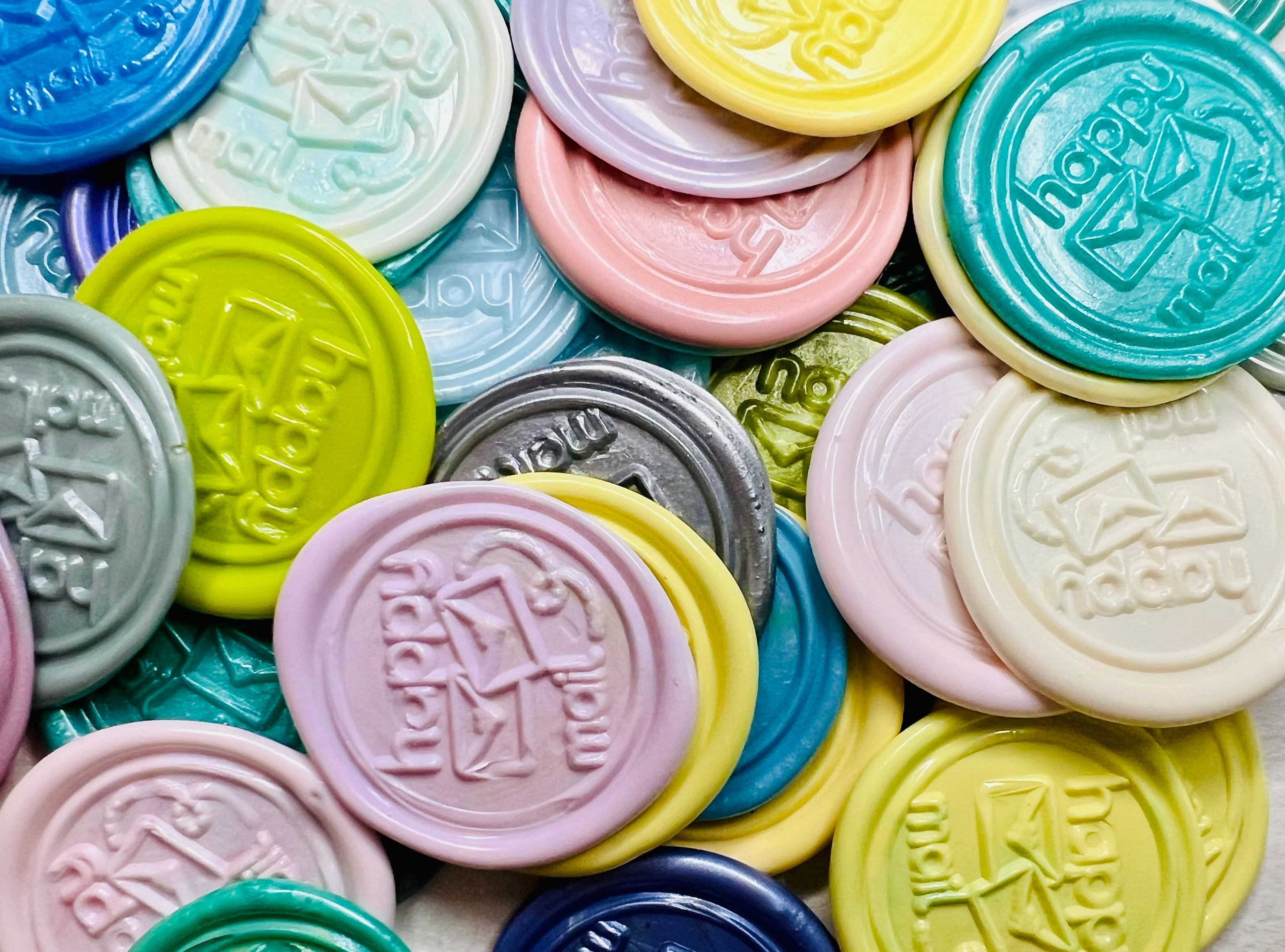 Pile of Happy Mail wax seal stickers in a pile in various colors