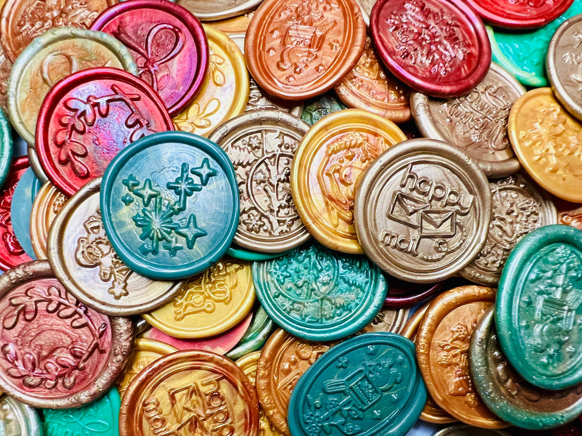 A variety of holiday inspired embossed wax seal stickers created by Rochambeau Home in a variety of colors.