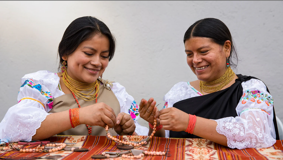 Two Latin women working on fiber art jewelry