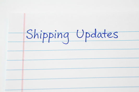 "Shipping Updates" handwritten on a piece of notebook paper.