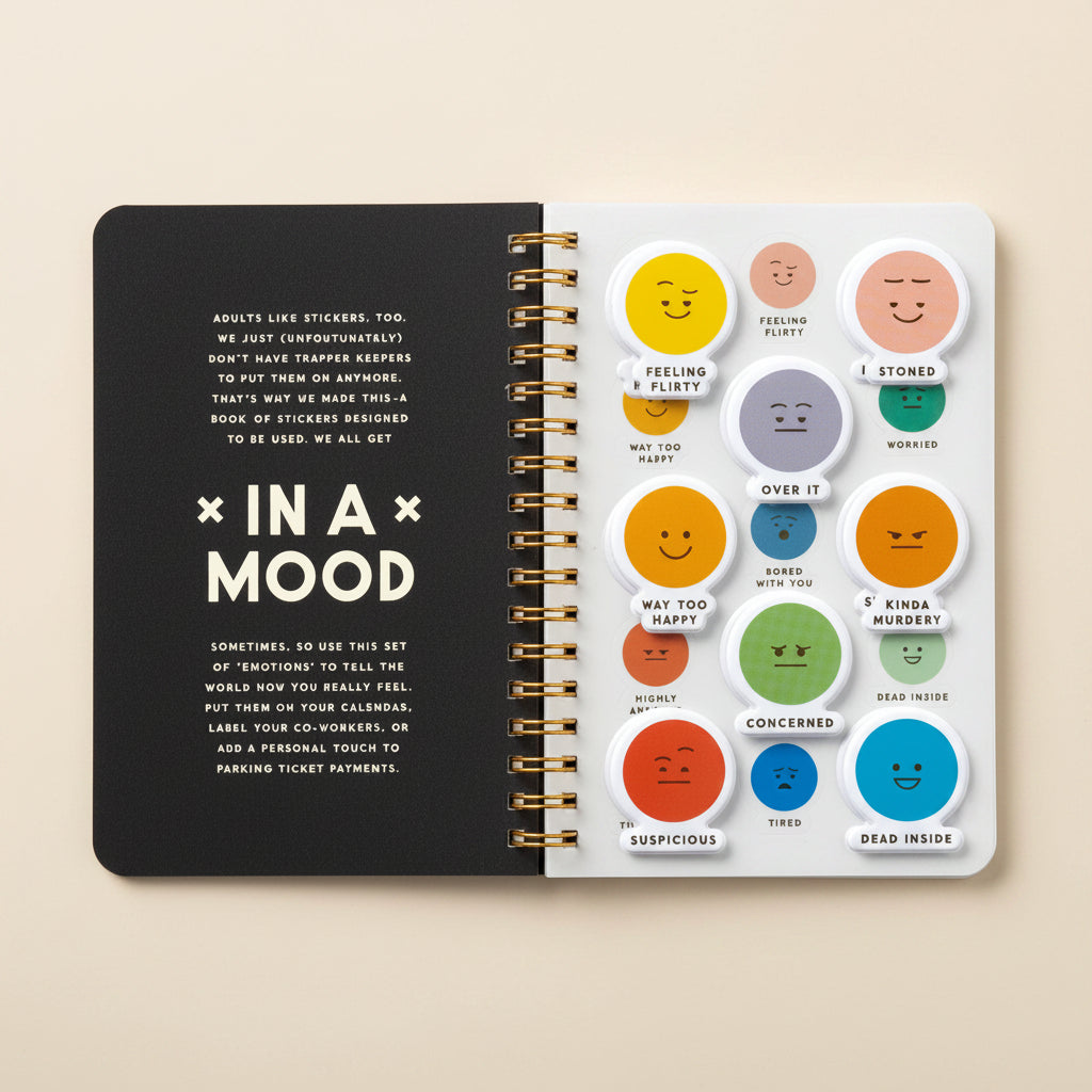 Sticker book featuring a variety of emoticon stickers displayed on a spiral‑bound notebook.