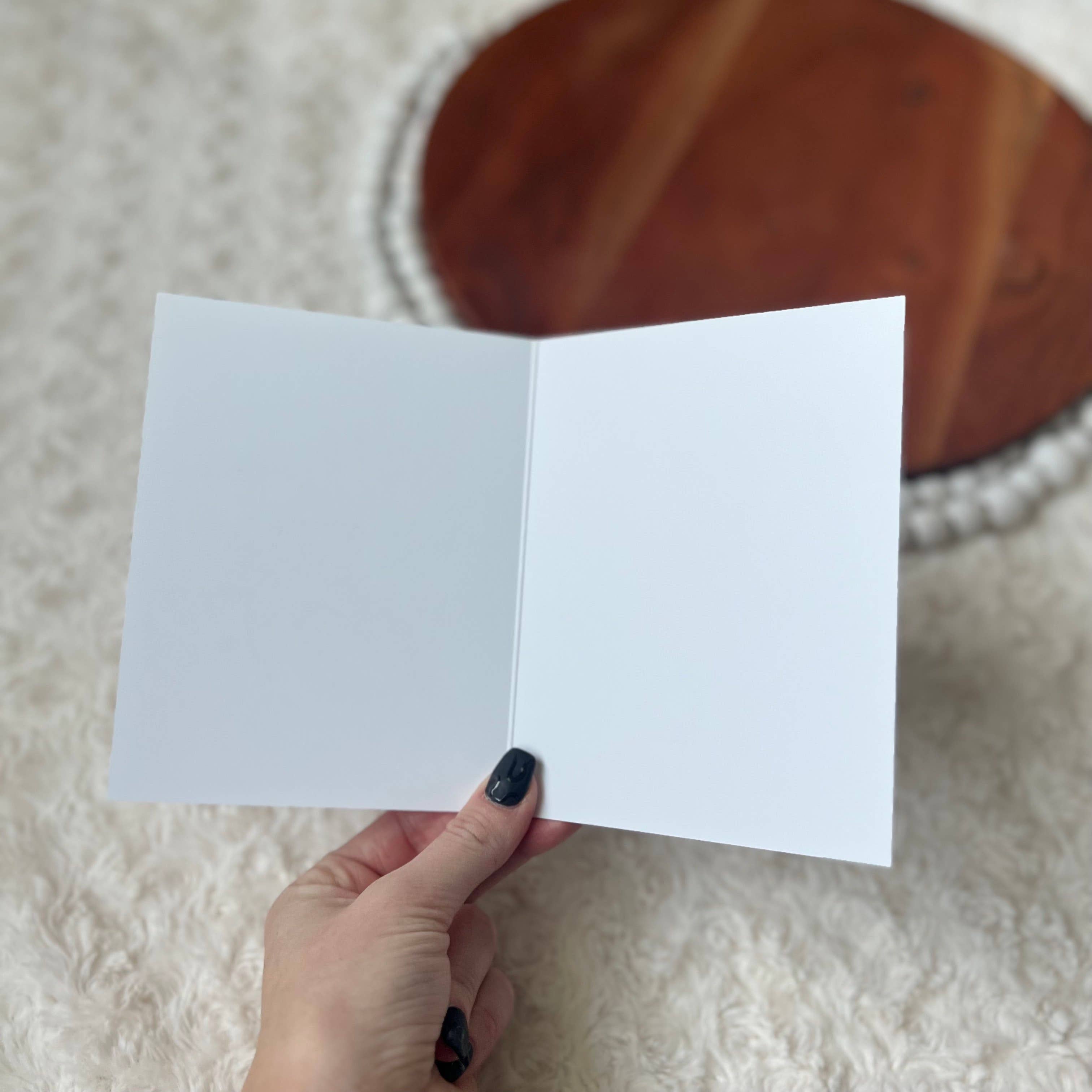 Interior of card shown blank with a pen ready for writing