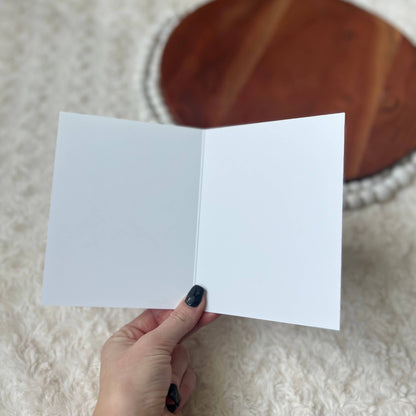 Interior of card shown blank with a pen ready for writing
