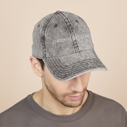 Man wearing a gray denim cap with "Chronic But Iconic" embossed on a white background