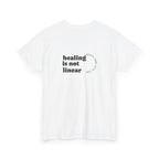 White t-shirt with 'healing is not linear' text on a white background