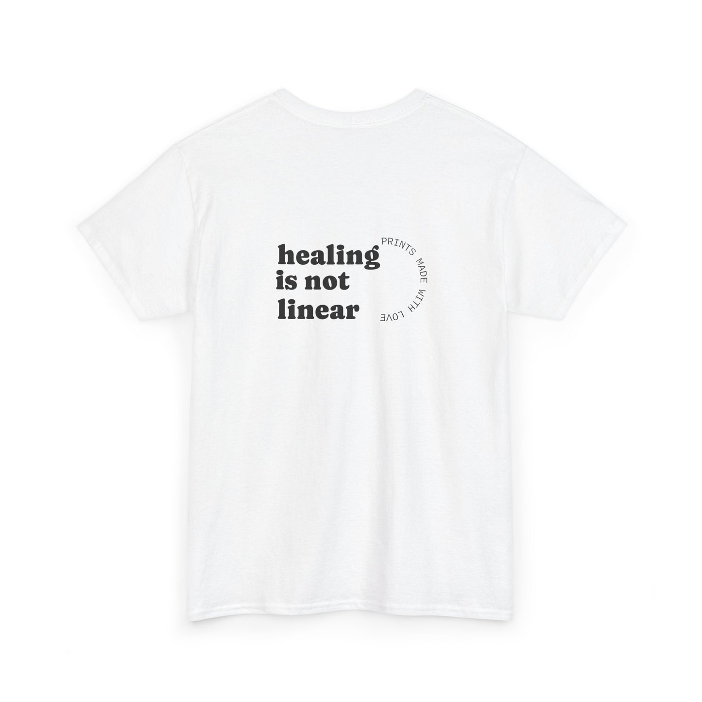White t-shirt with 'healing is not linear' text on a white background