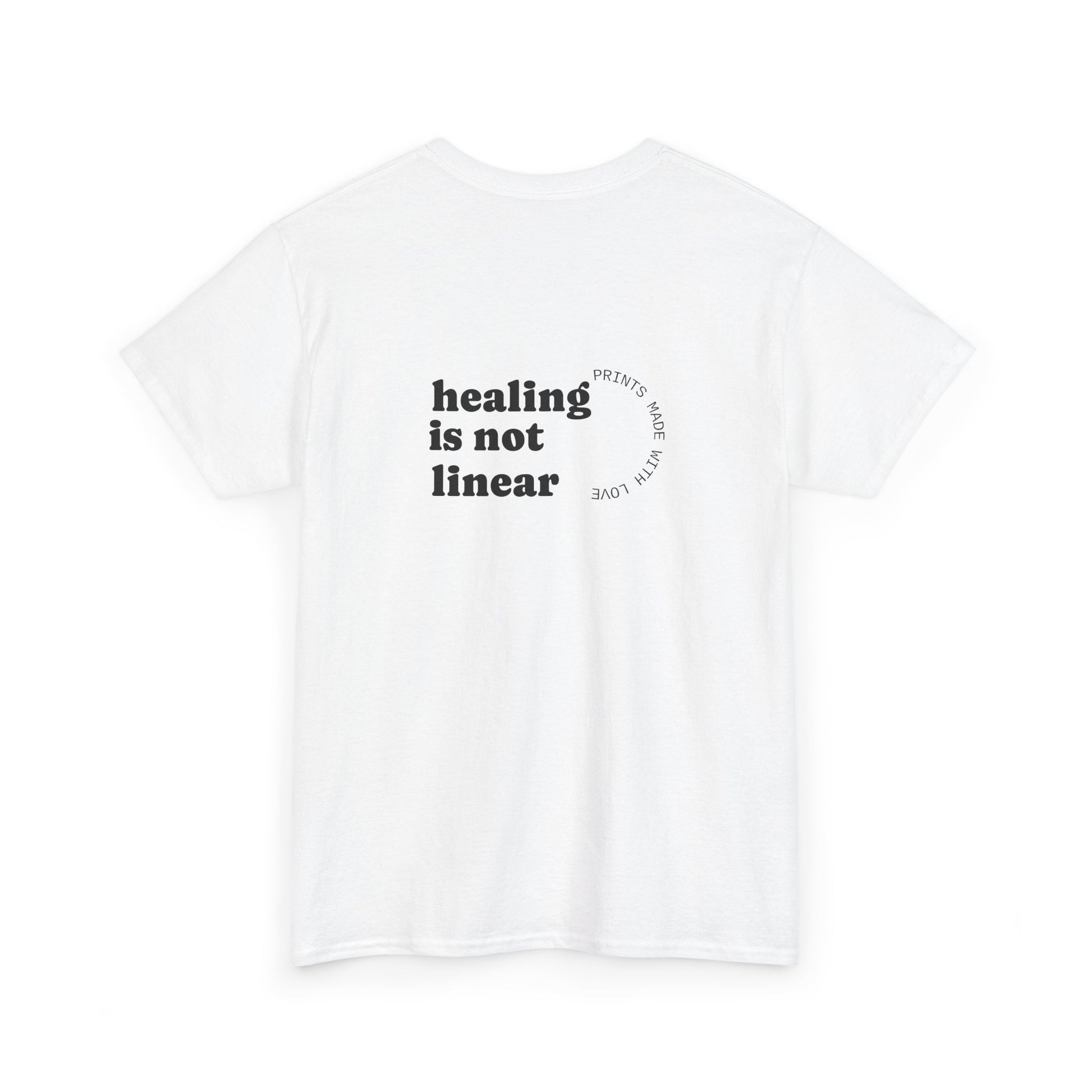 White t-shirt with 'healing is not linear' text on a white background