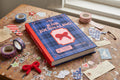 Book titled 'A Year of Junk Journaling' surrounded by vintage materials on a textured surface