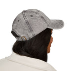 Person wearing a gray denim cap on a white background