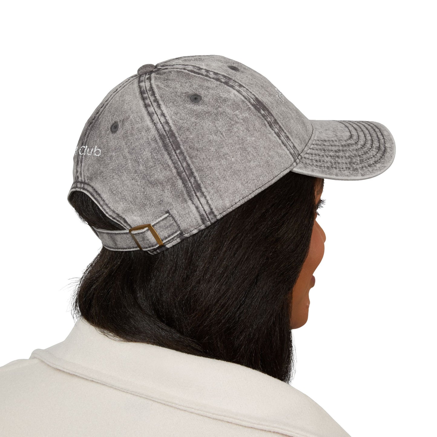 Person wearing a gray denim cap on a white background