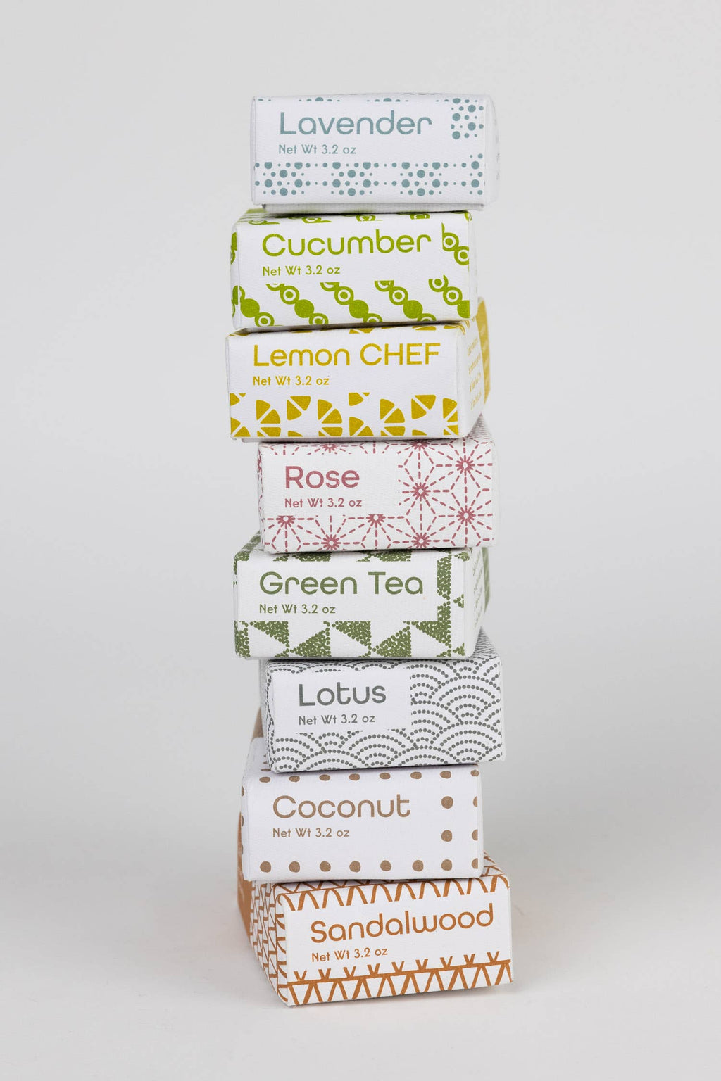 Stack of tea boxes with various flavors on a white background