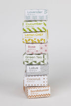Stack of tea boxes with various flavors on a white background