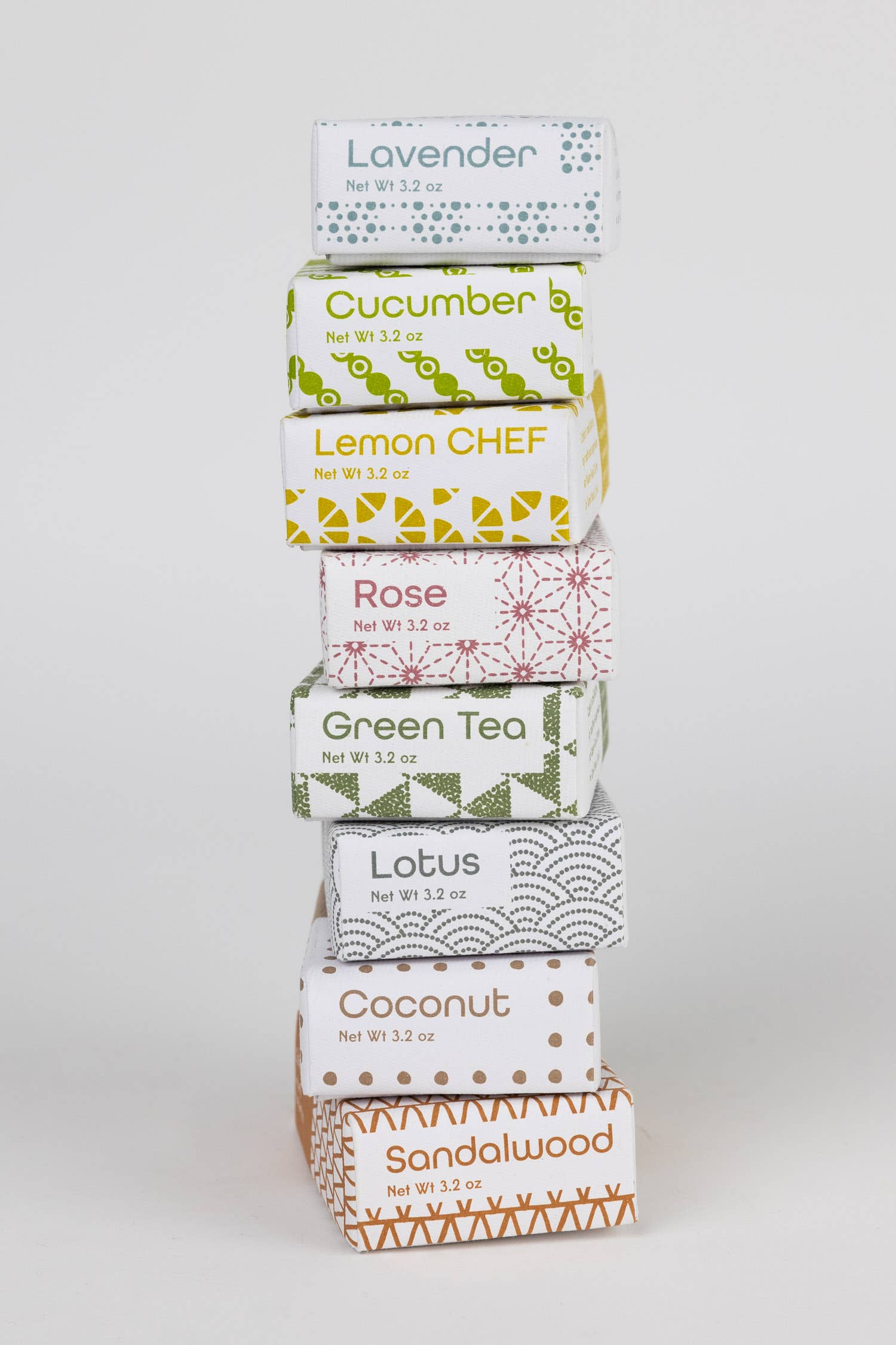Stack of tea boxes with various flavors on a white background