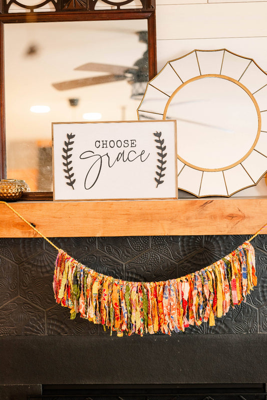 Decorative banner with 'Choose Grace' sign on a mantelpiece.