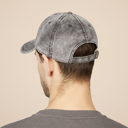 Person wearing a gray denim cap on a white background showcasing the back of the hat