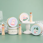 Vanilla and espresso scented candle in white tin with corked vial of colorful matchsticks, packaged in a clear vinyl gift box.