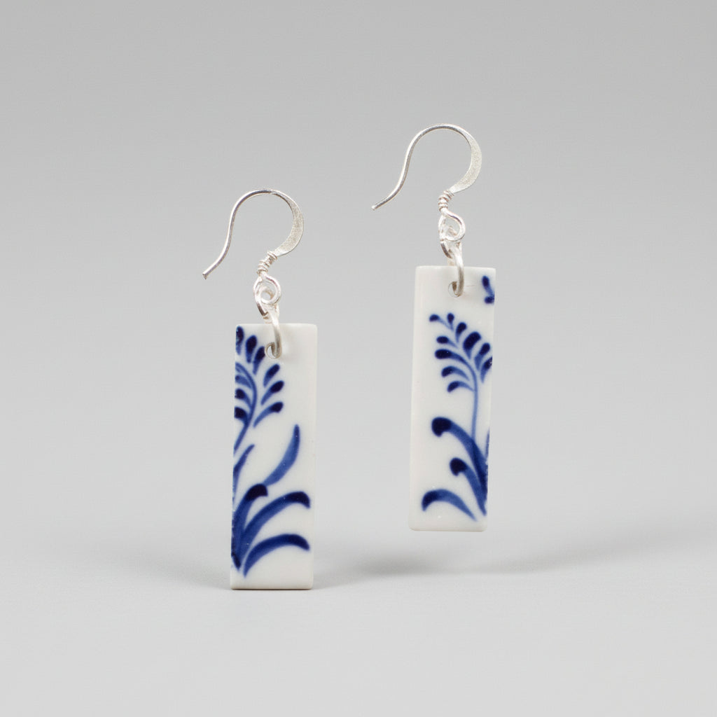 Rectangular white ceramic earrings with hand-painted blue botanical designs