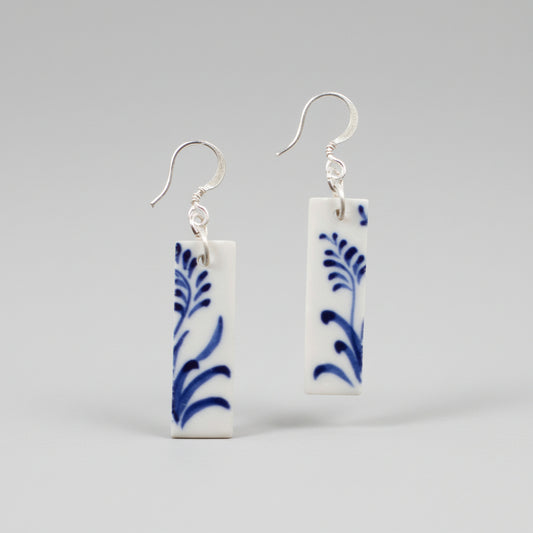 Rectangular white ceramic earrings with hand-painted blue botanical designs