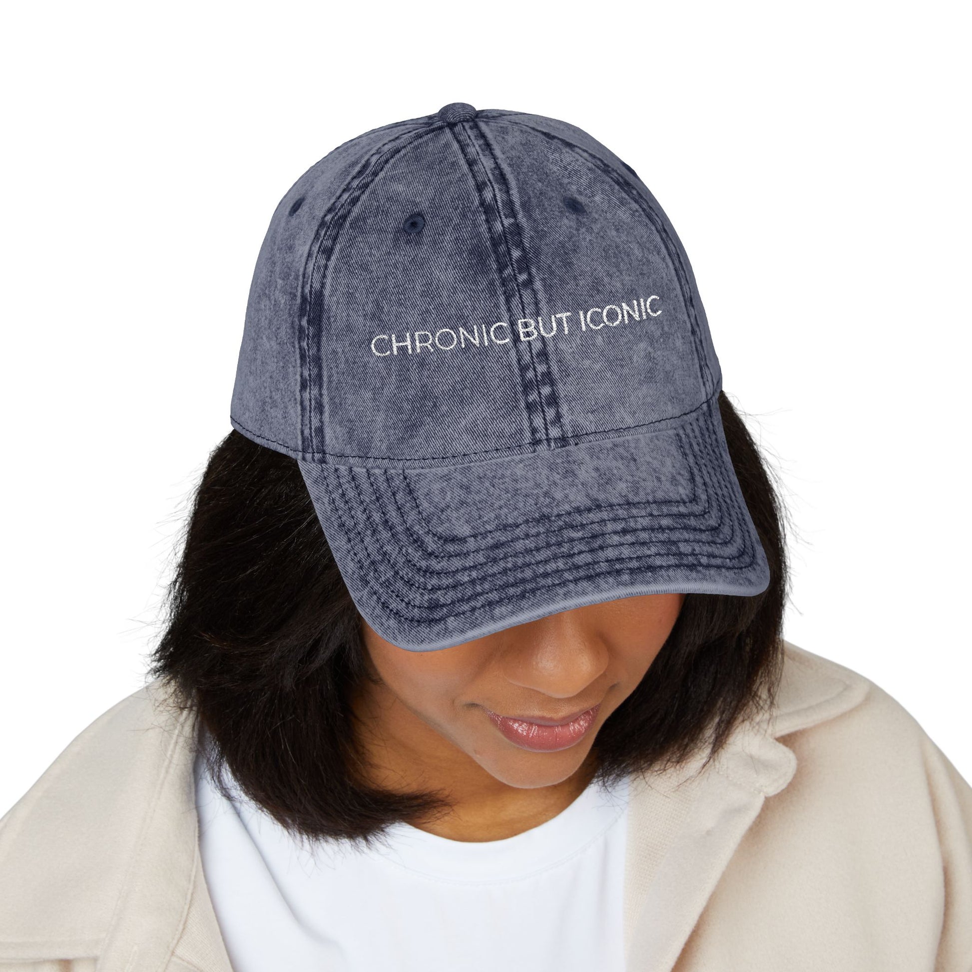 Person wearing a denim cap with 'Chronic But Iconic' text on a white background