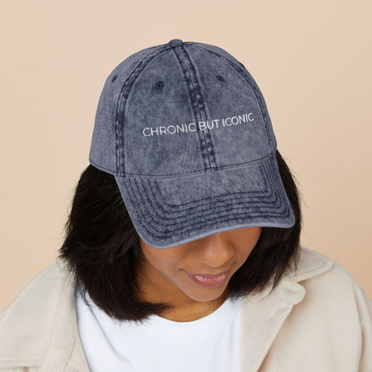Person wearing a denim cap with 'Chronic But Iconic' text on a white background
