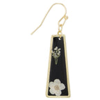Gold earring with black triangle pendant featuring floral designs on a white background