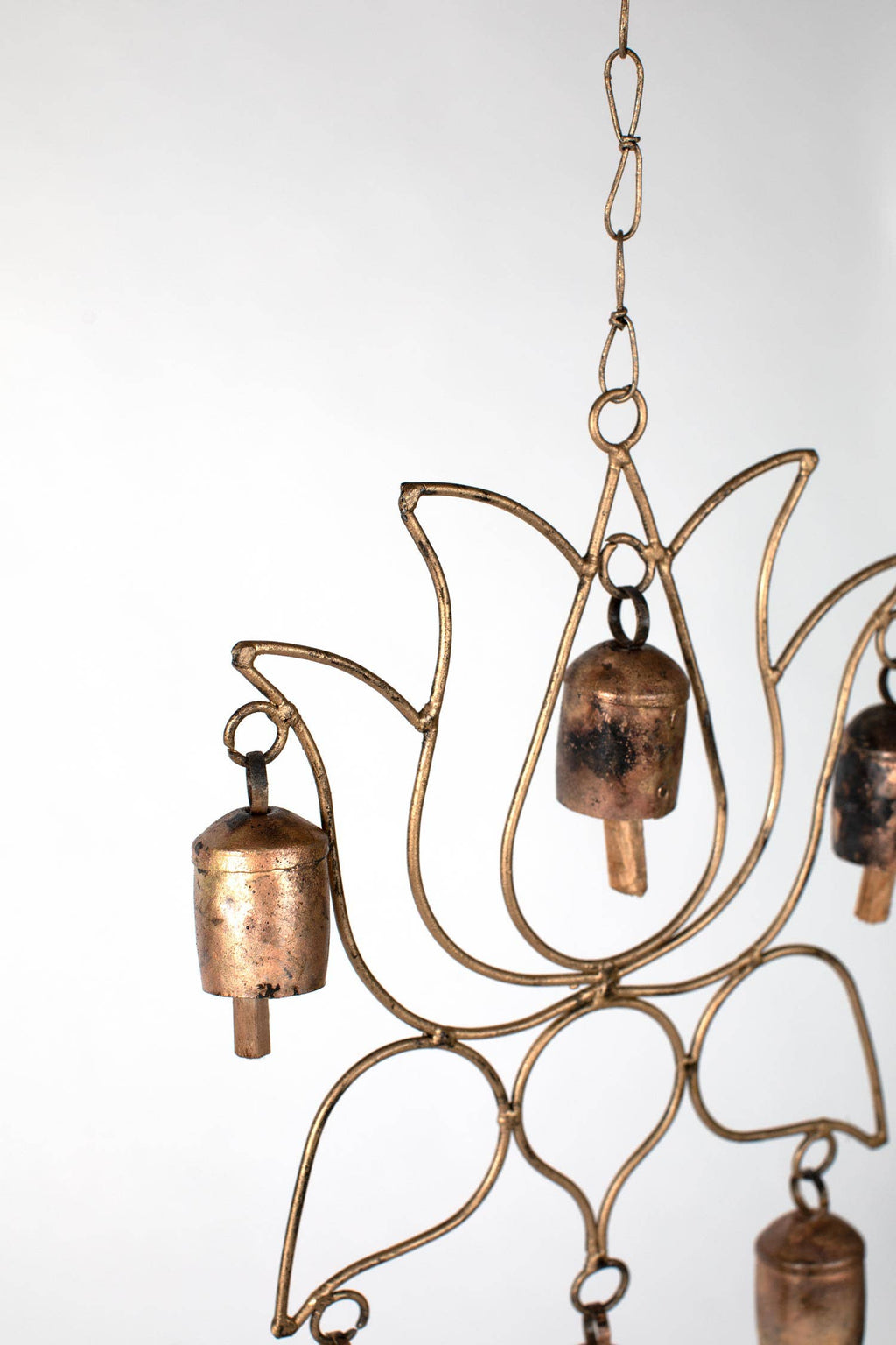 Close-up of recycled iron bells and mango wood detailing