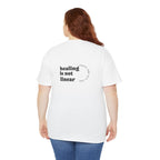 Person wearing a white t-shirt with 'healing is not linear' text on the back, standing against a white background.