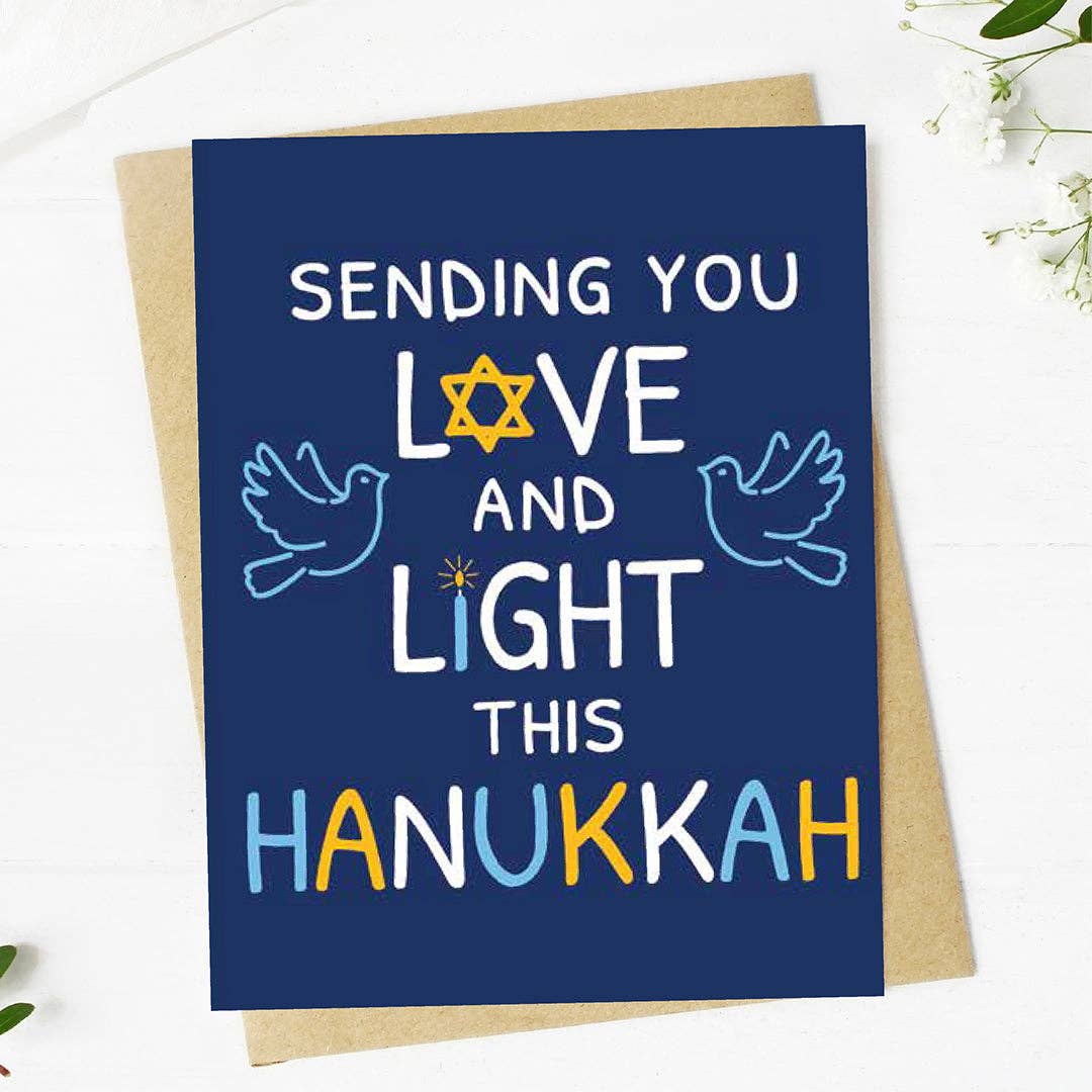 Hanukkah card with text 'Sending you love and light this Hanukkah' on a blue background with a star of David, doves, and colorful letters.