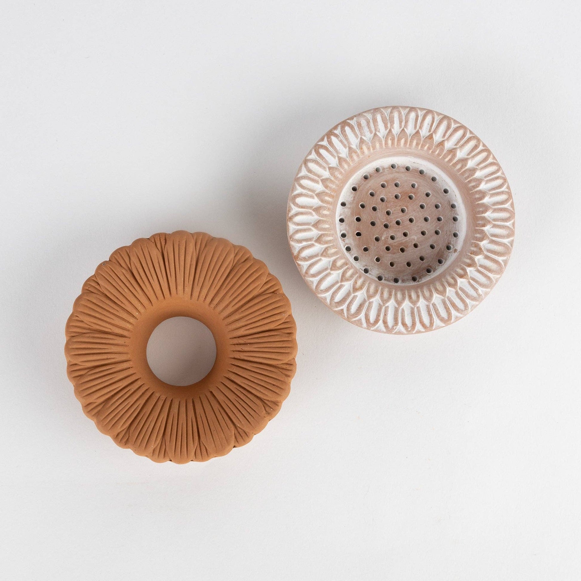 Two ceramic pots with textured surfaces on a white background