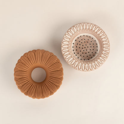 Two ceramic pots with textured surfaces on a white background