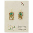 Cottagecore earrings styled with a linen top and soft lighting