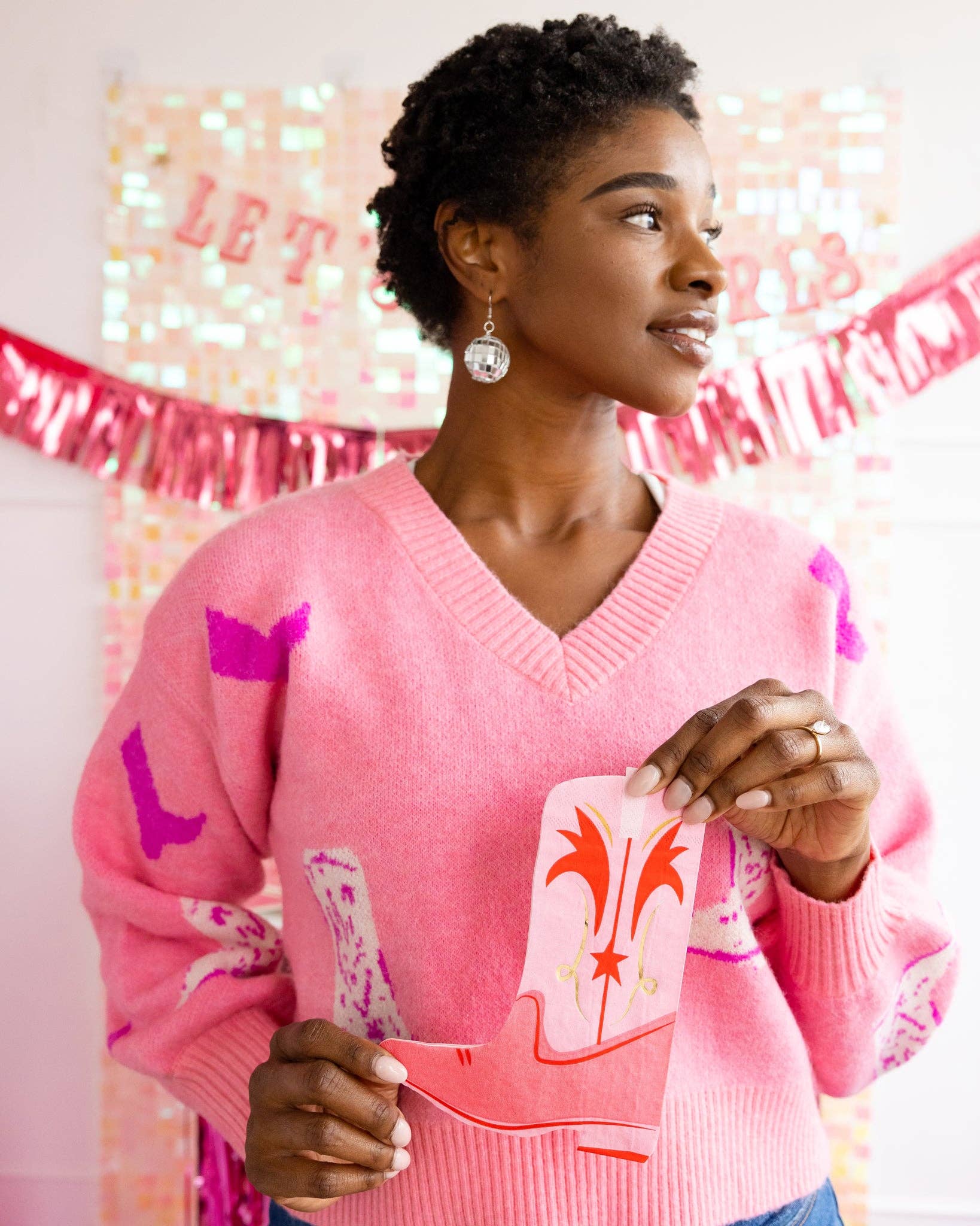 Showing off Pink boot-shaped dinner napkins with gold foil accents