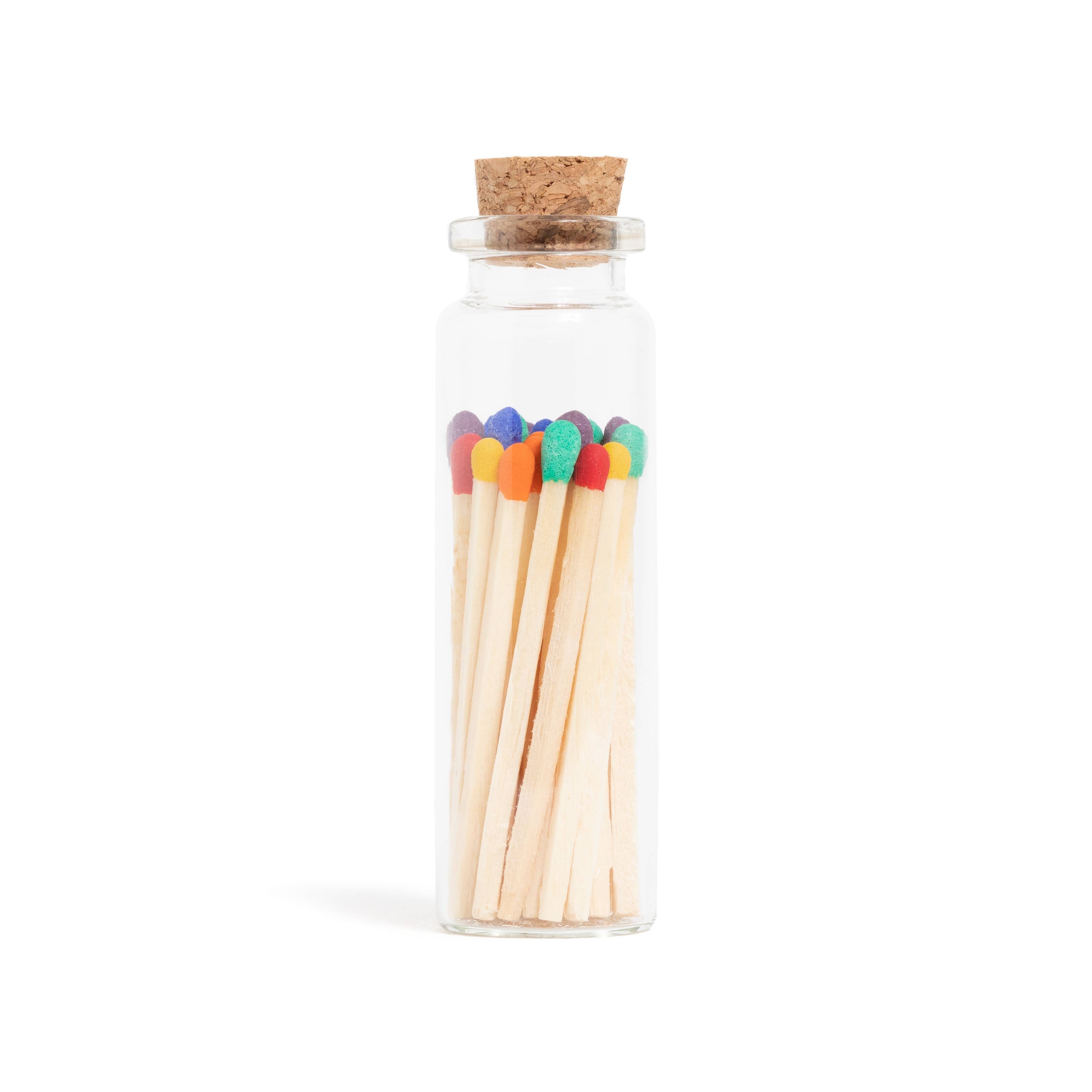 Rainbow-colored wooden matchsticks in a corked glass vial – vibrant matches perfect for candles, wedding favors, and gifts.