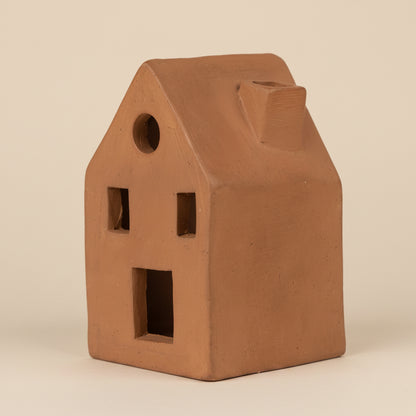 Up close view of the terracotta incense holder shaped like a home