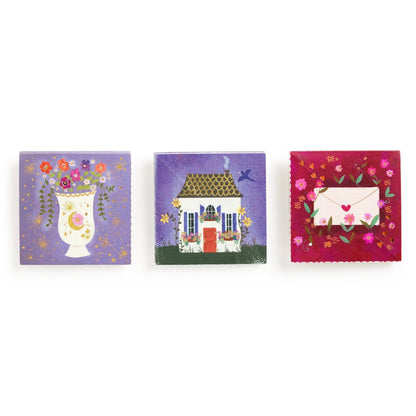 Three small square paintings on a white background