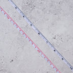 Measuring tape extended, showing inches clearly marked against the white tape