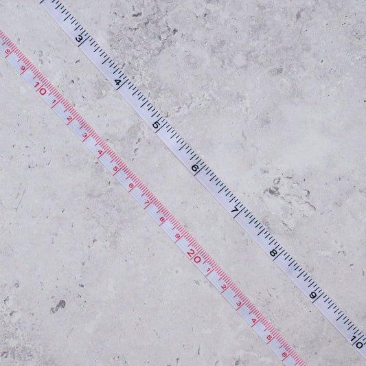 Measuring tape on a concrete surface