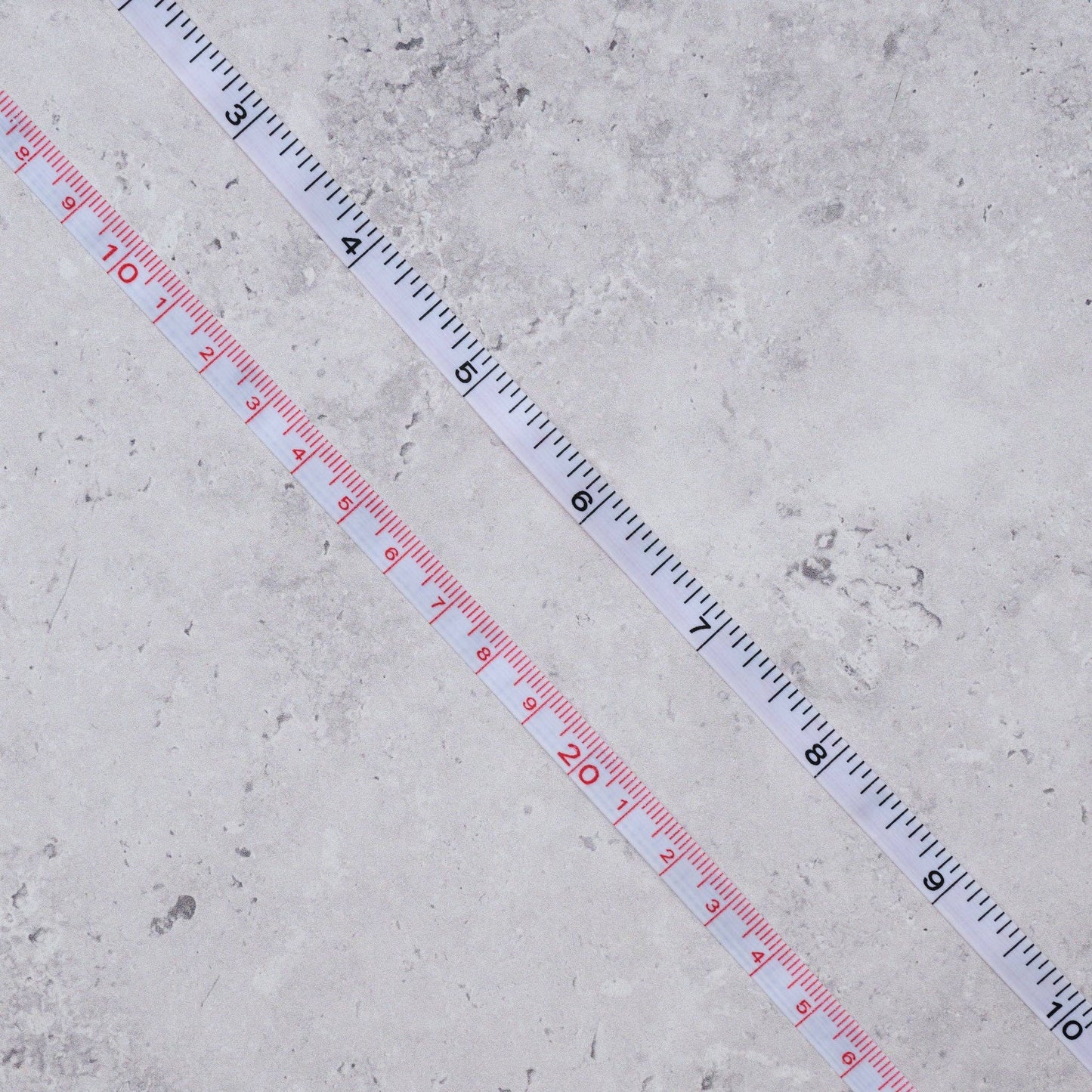 Extended measuring tape on a concrete surface