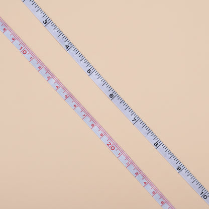 Extended measuring tape on a concrete surface